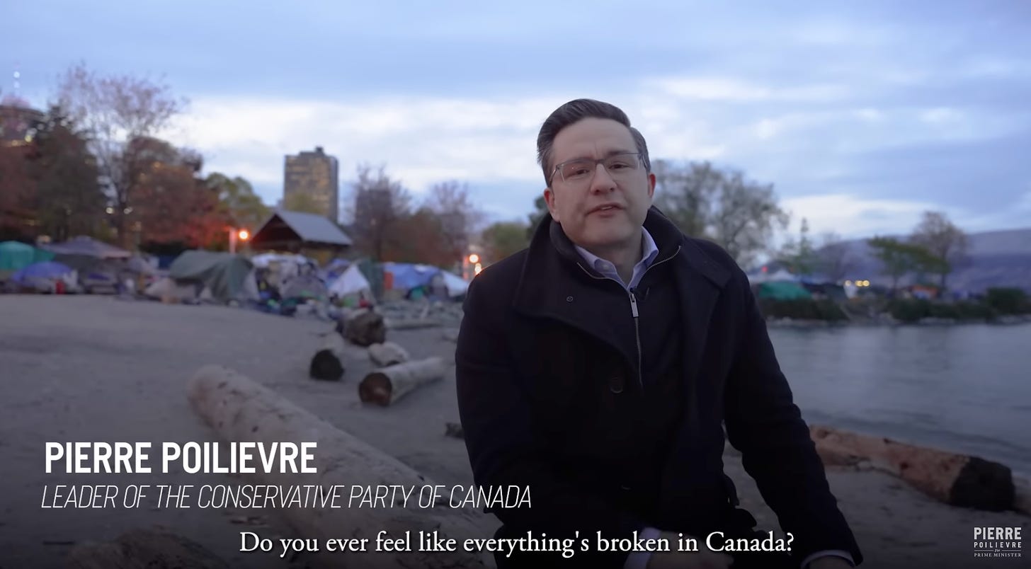 Pierre Poilievre, leader of the Conservative Party of Canada, sits on a log on the beach in Crab Park in Vancouver for his video "Everything feels broken" that was published last November. Behind him is a tent city, and the closed captioning says "Do you ever feel like everything's broken in Canada?"