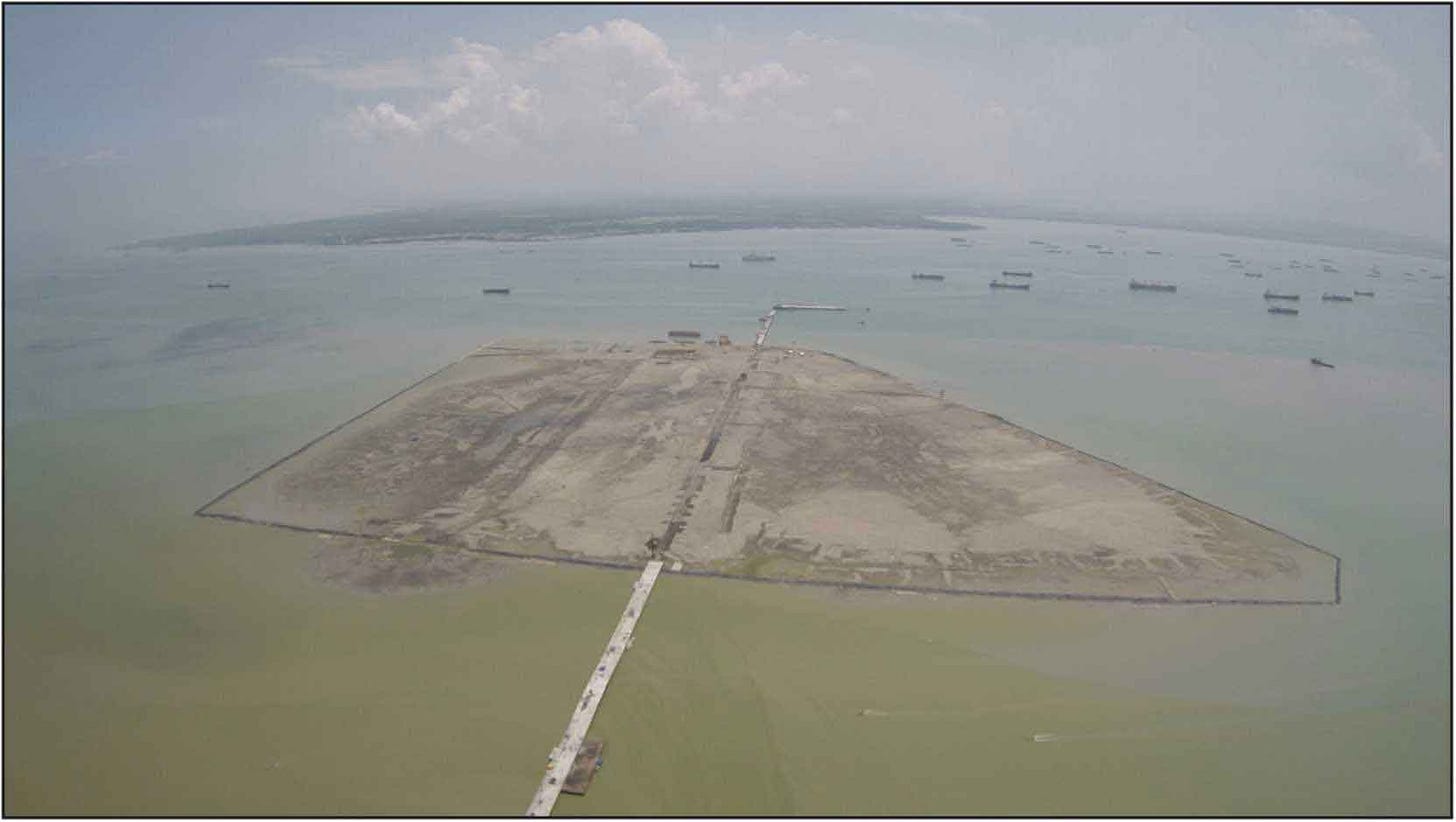 Picture of a flat island connected to the mainland by a narrow causeway Picture of a flat island connected to the mainland by a narrow causeway