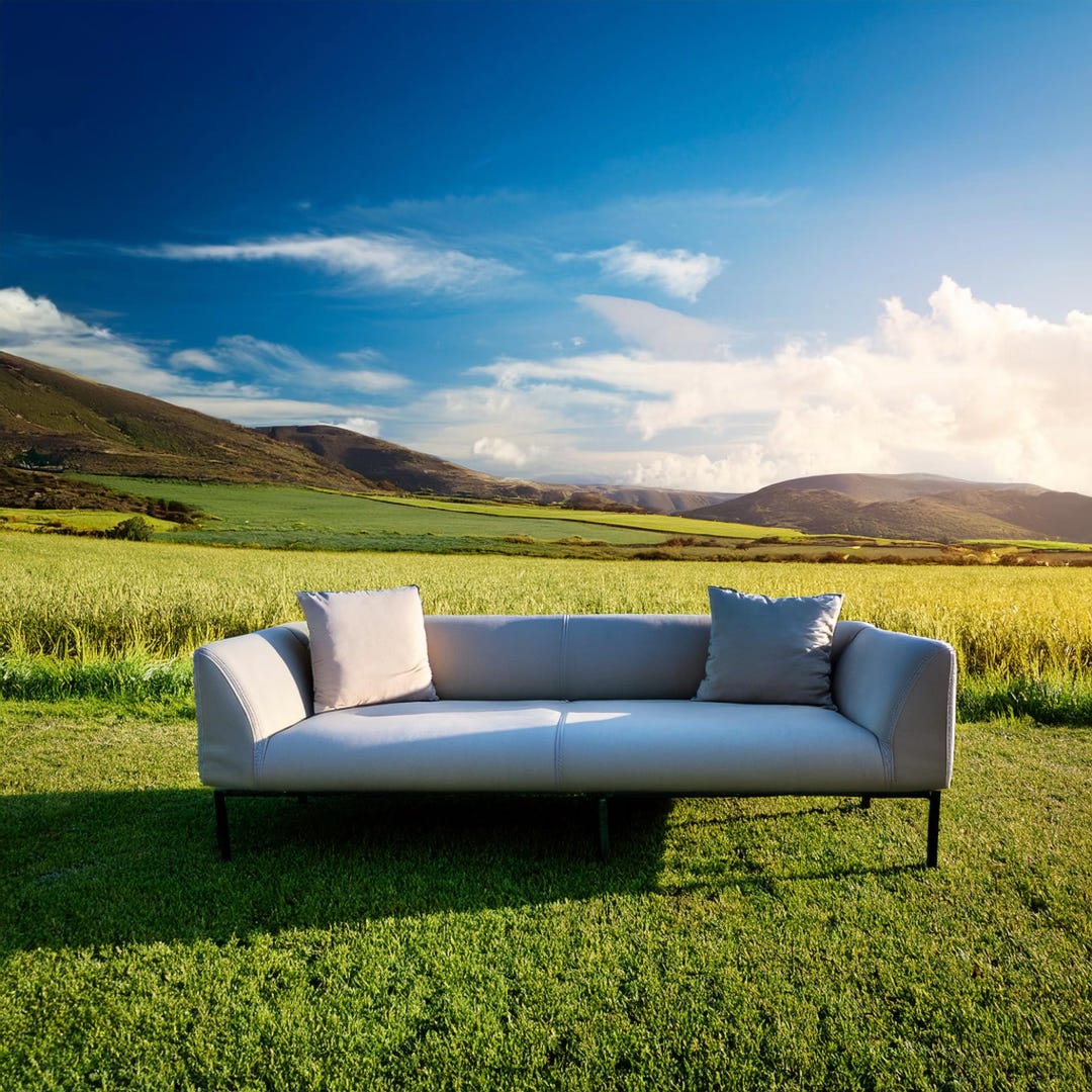 Modern looking couch in the middle of an open field