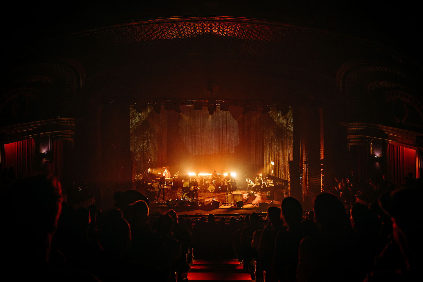 Wilco perform at the Riviera Theatre in Chicago in front of draped fiber set design.