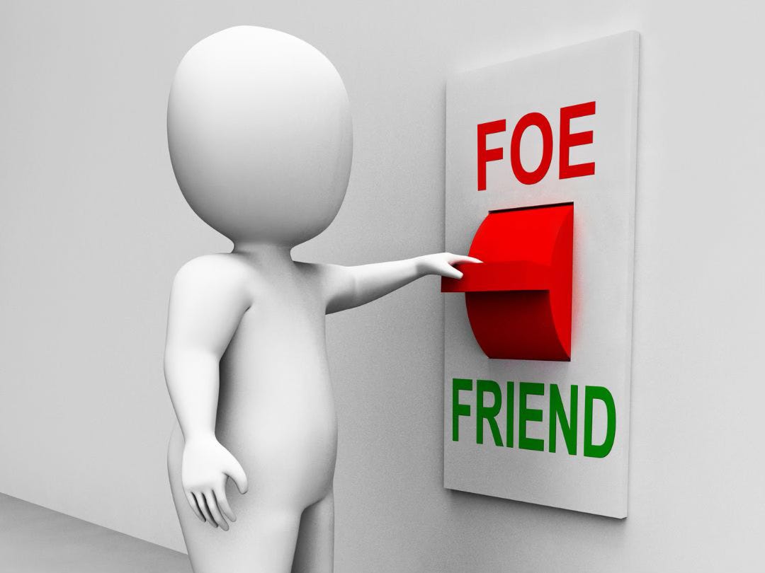 A person standing in front of a switch on the wall with a choice between "friend" or "foe".