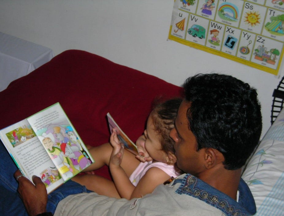 child having storytime with her dad