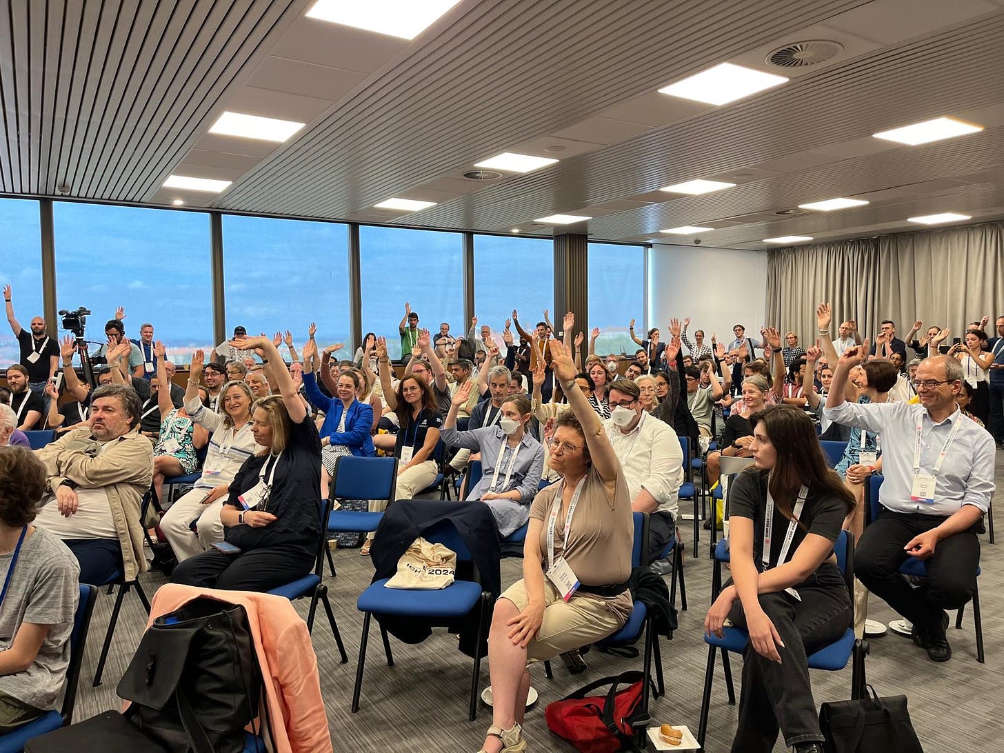 The audience almost all raising their hands