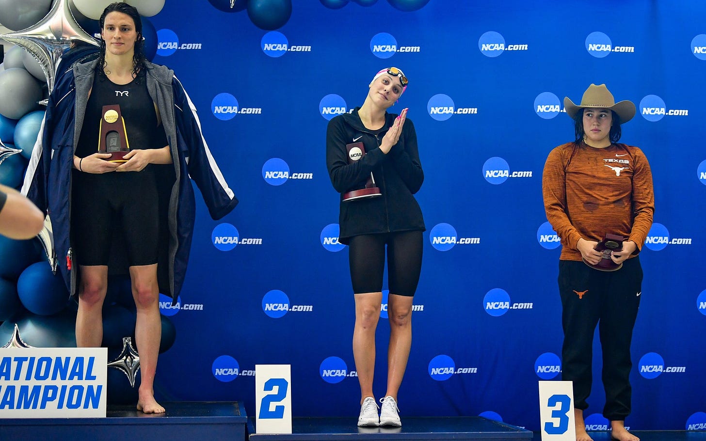 Female swimmers beaten by transgender athlete stage podium protest at  'unfair' result