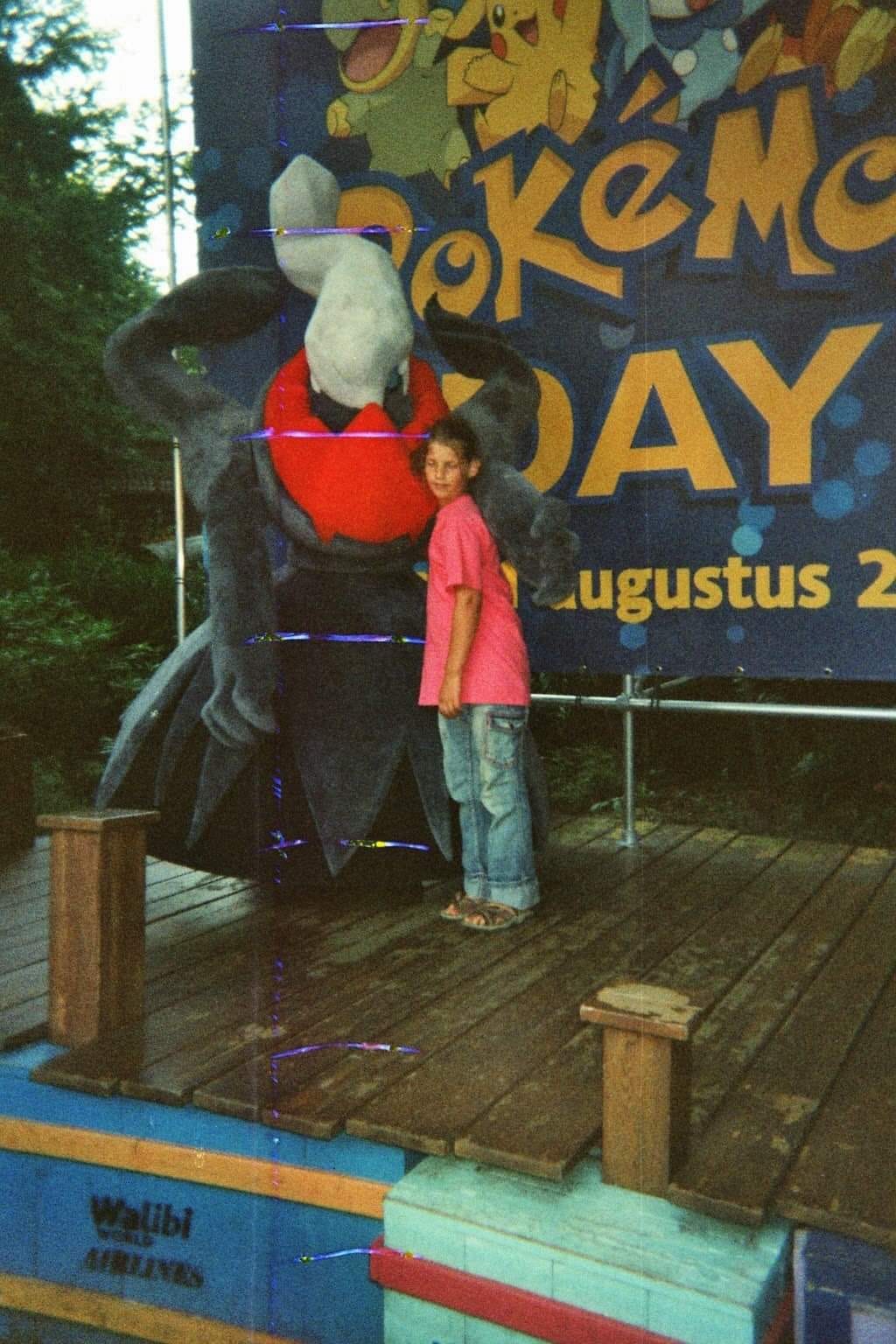 A photograph of Kimberley with a Darkrai mascot