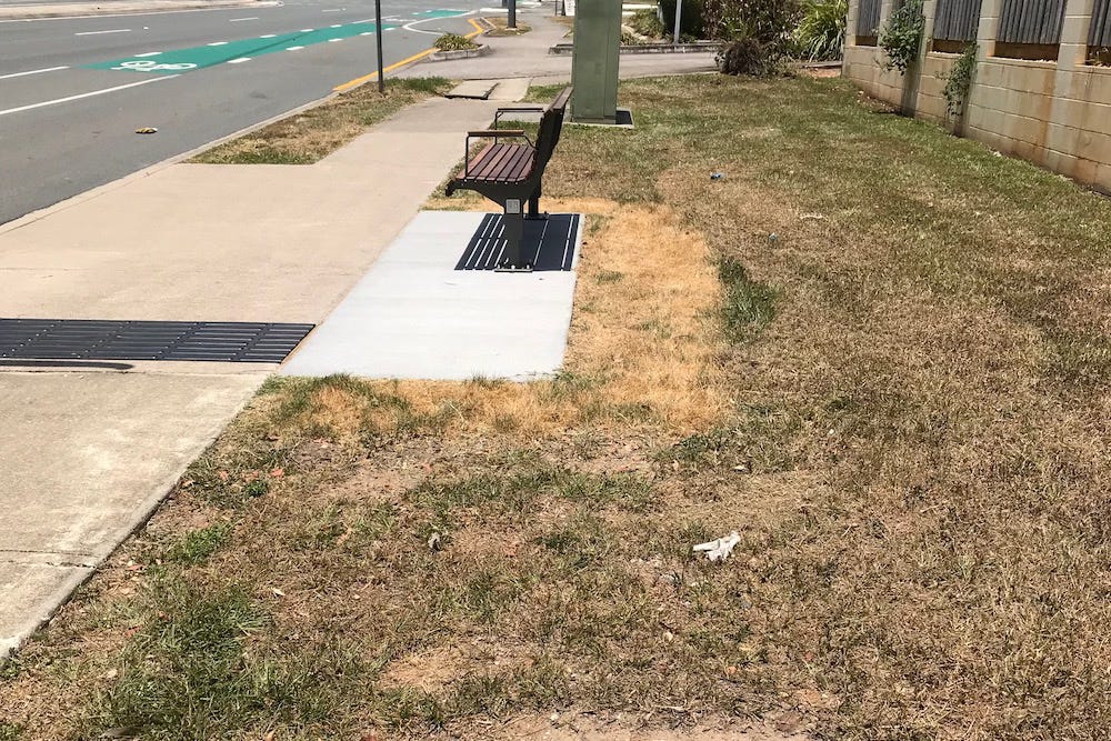 photo of a barren bus stop after its upgrade to meet disability standards