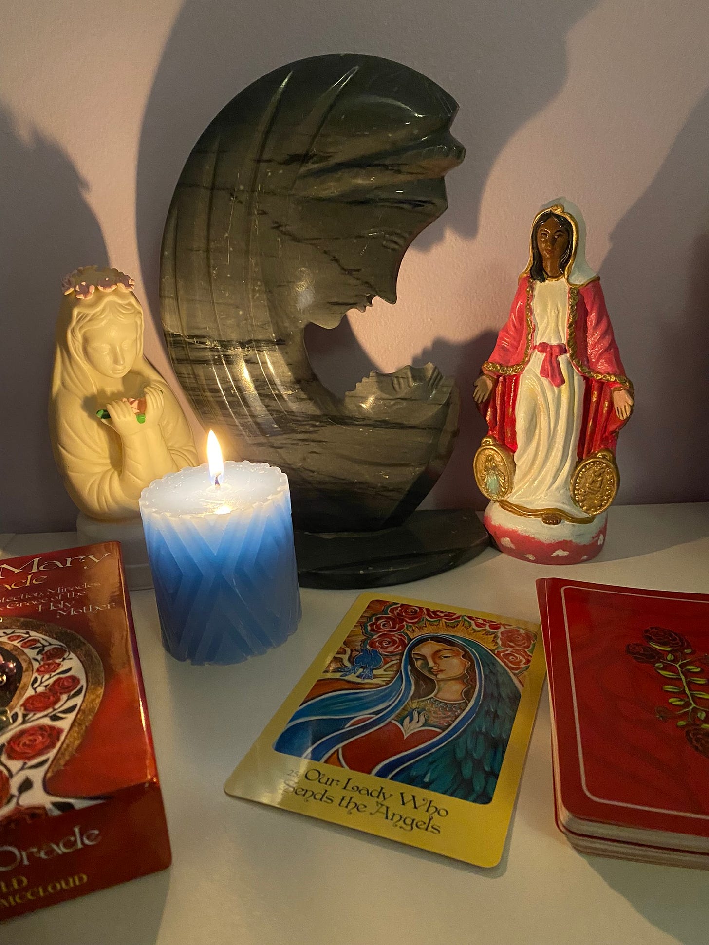 Home shrine to Mary with a candle in the foreground