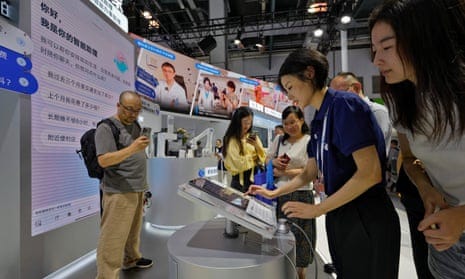 Vistors trying out an AI assistant program at the Baidu stand