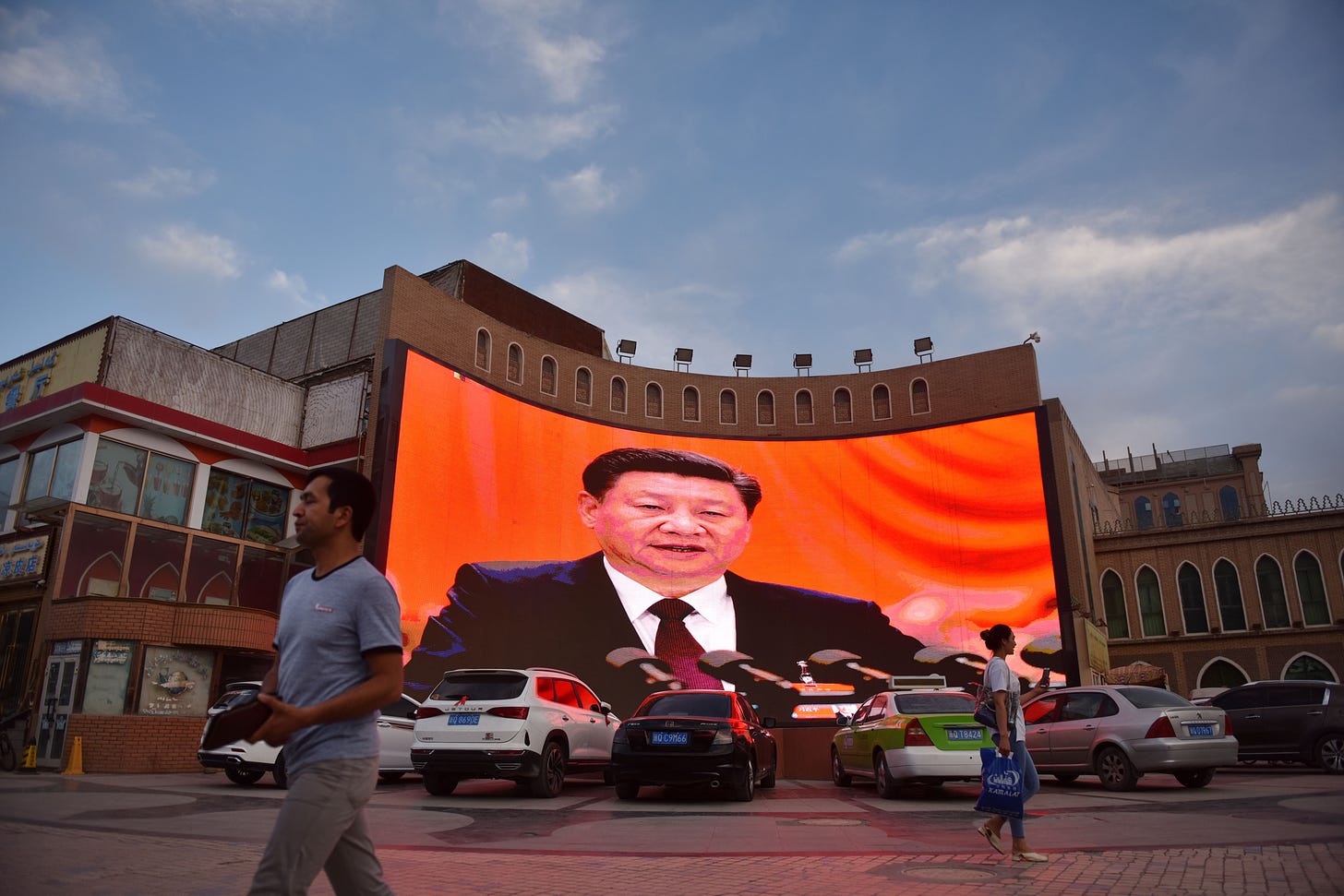 Screen showing Chairman Xi Jinping in Xinjiang, June 4, 2019. (Photo by Greg Baker/AFP via Getty Images.)