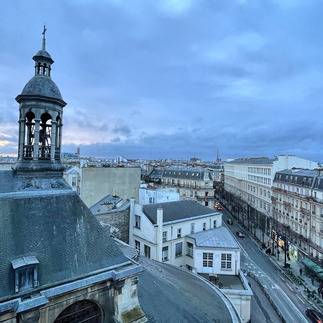 Overlooking the streets of Paris, a church on the foreground