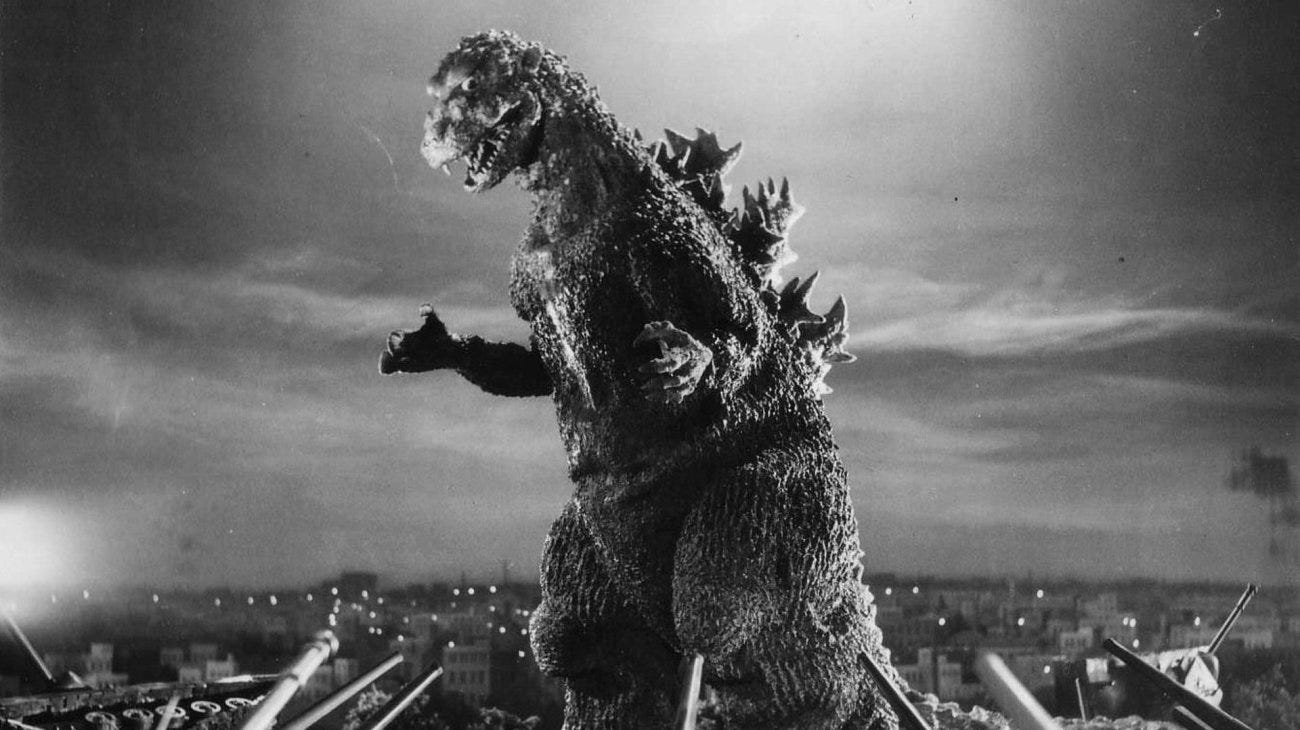 black and white godzilla towering over mega tokyo