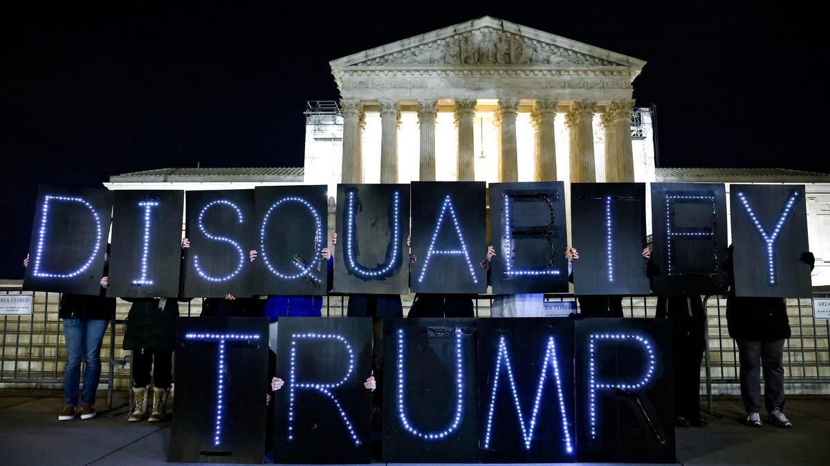 WASHINGTON, DC - FEBRUARY 01: MoveOn members hold signs that say "Disqualify Trump" during a rally outside of the U.S. Supreme Court of the United States on February 01, 2024 in Washington, DC. (Photo by Paul Morigi/Getty Images for MoveOn) ORG XMIT: 776100704 ORIG FILE ID: 1978795202