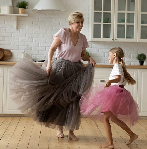 older woman dancing with young girl
