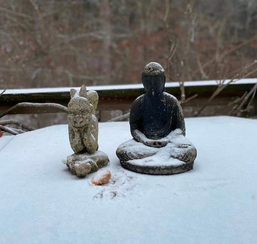 Photo of John de Gargoyle and Formcast Buddha on the same table, only covered in snow.