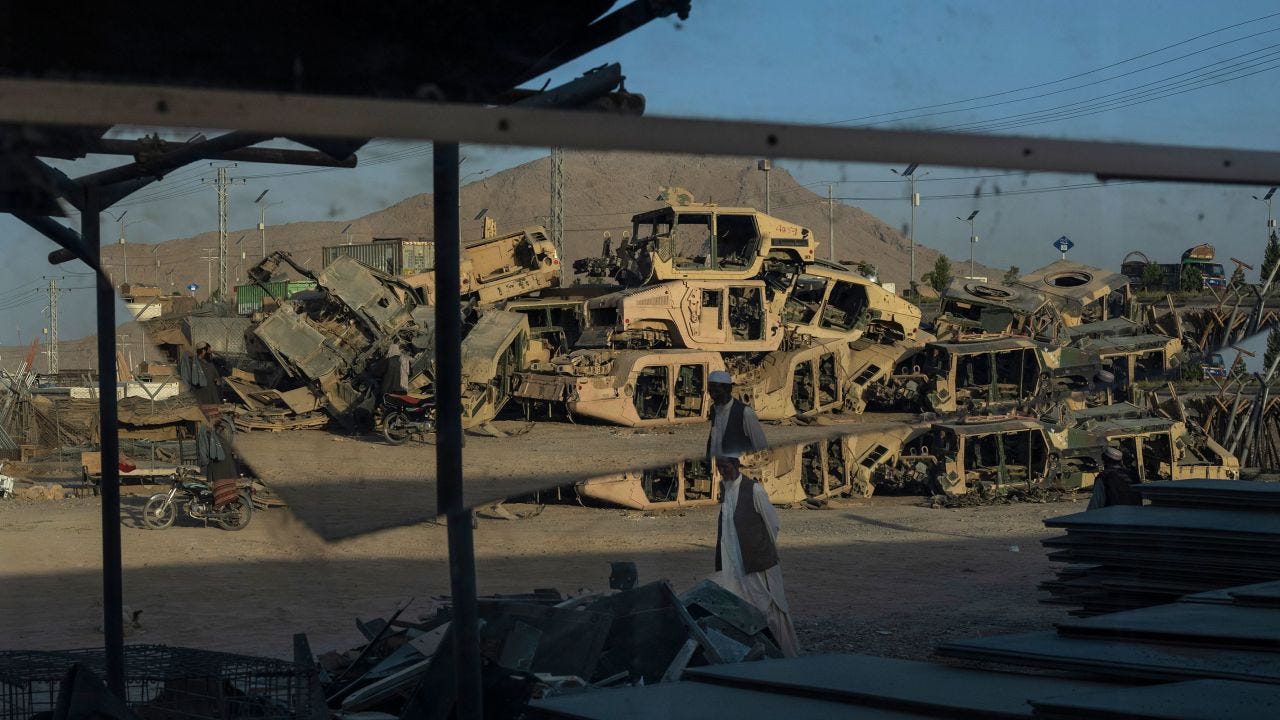 Destroyed Humvees used during the war against the Taliban are seen stacked to be sold as scrap metal in Kandahar City, Afghanistan, on June 12, 2023.