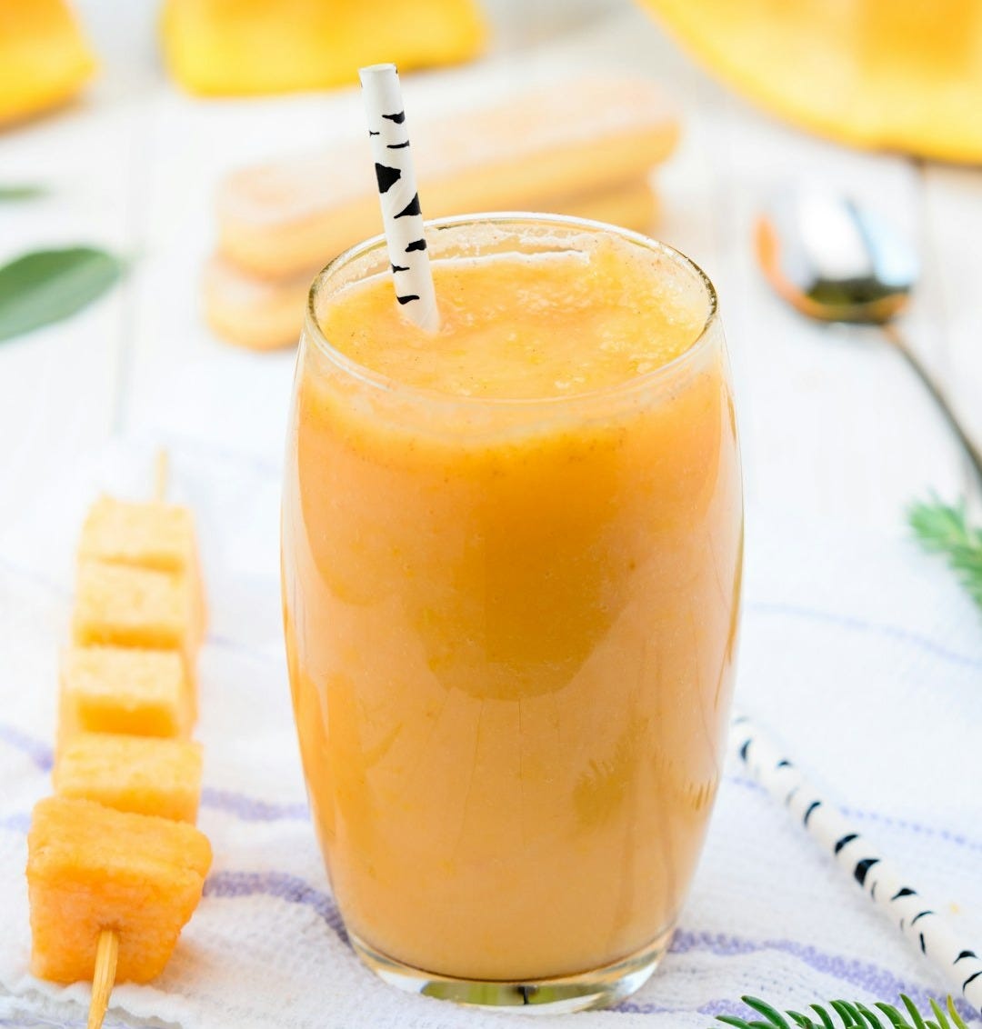 yellow fruit juice on glass cup yellow fruit juice on glass cup
