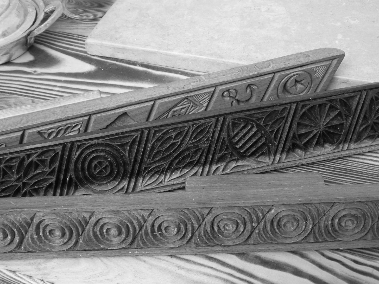 Three wooden long moulds