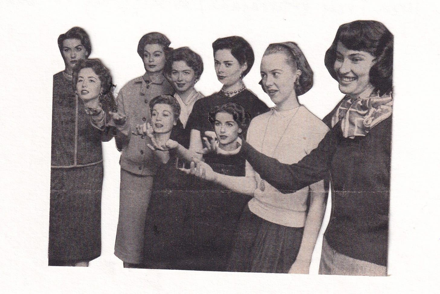 6 models in a vintage black and white photo stand with one hand extended each; in three of these hands are yet more women's heads.