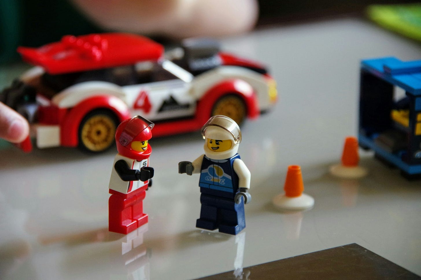 a lego man and a lego car on a table a lego man and a lego car on a table
