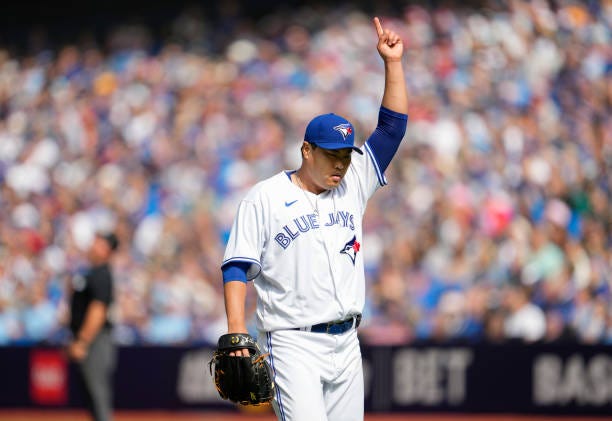 Hyun Jin Ryu of the Toronto Blue Jays points to the sky at end of the second inning against the Boston Red Sox in their MLB game at the Rogers Centre...