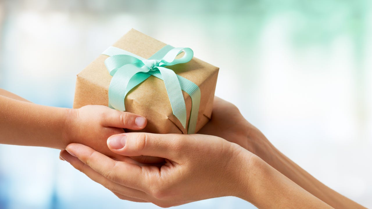 A person giving a gift to another person.