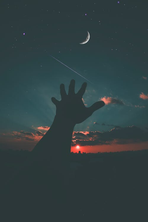 Free Person Hand and Crescent Moon Stock Photo