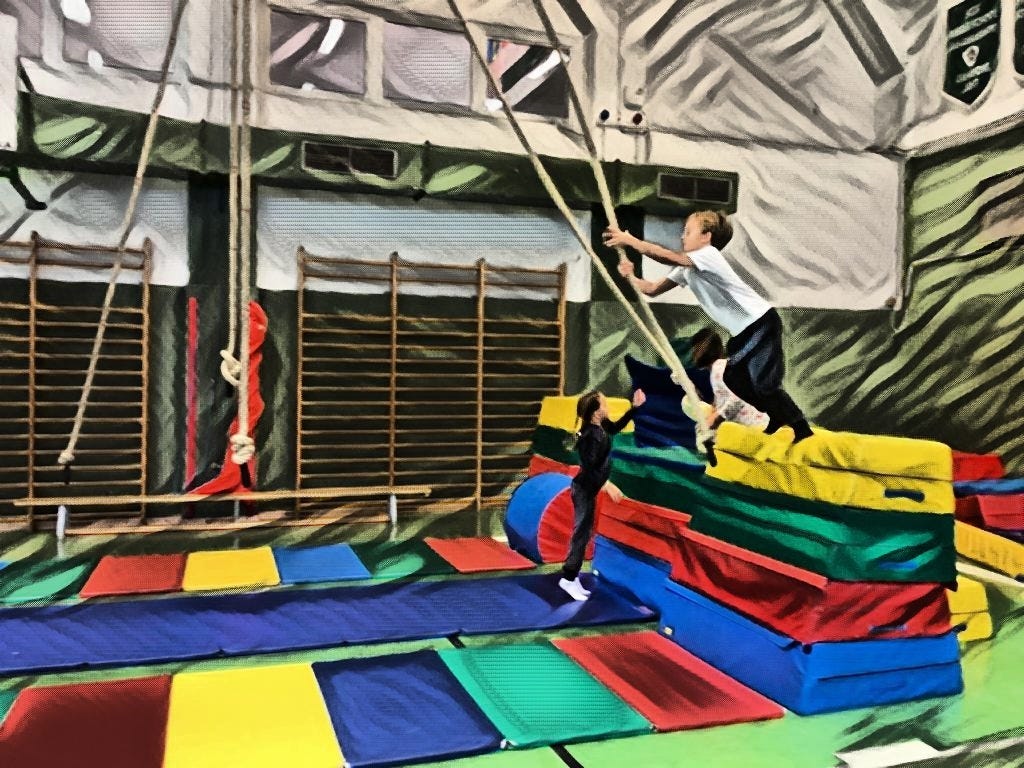 Digitally altered photograph of student reaching for climbing rope to swing from a brightly colored piece of equipment. Photo looks like a painting.