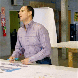 marcus lemonis from the profit flopping over a table in resignation