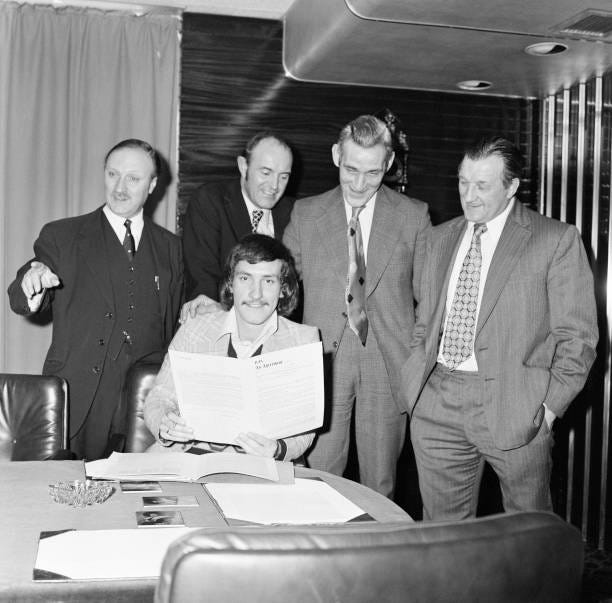 Terry McDermott, midfielder, formerly of Newcastle United, signs for Liverpool Football Club. Pictured with Chairman John Smith, Secretary Peter...
