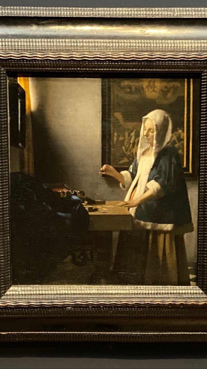 Woman Holding a Balance by Vermeer
