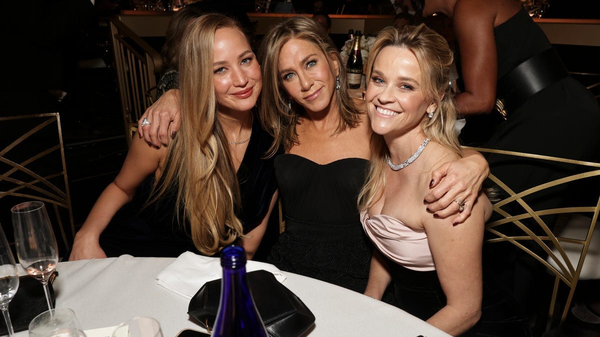 Jennifer Lawrence, Jennifer Aniston and Reese Witherspoon share a moment at the 81st Annual Golden Globe Awards.