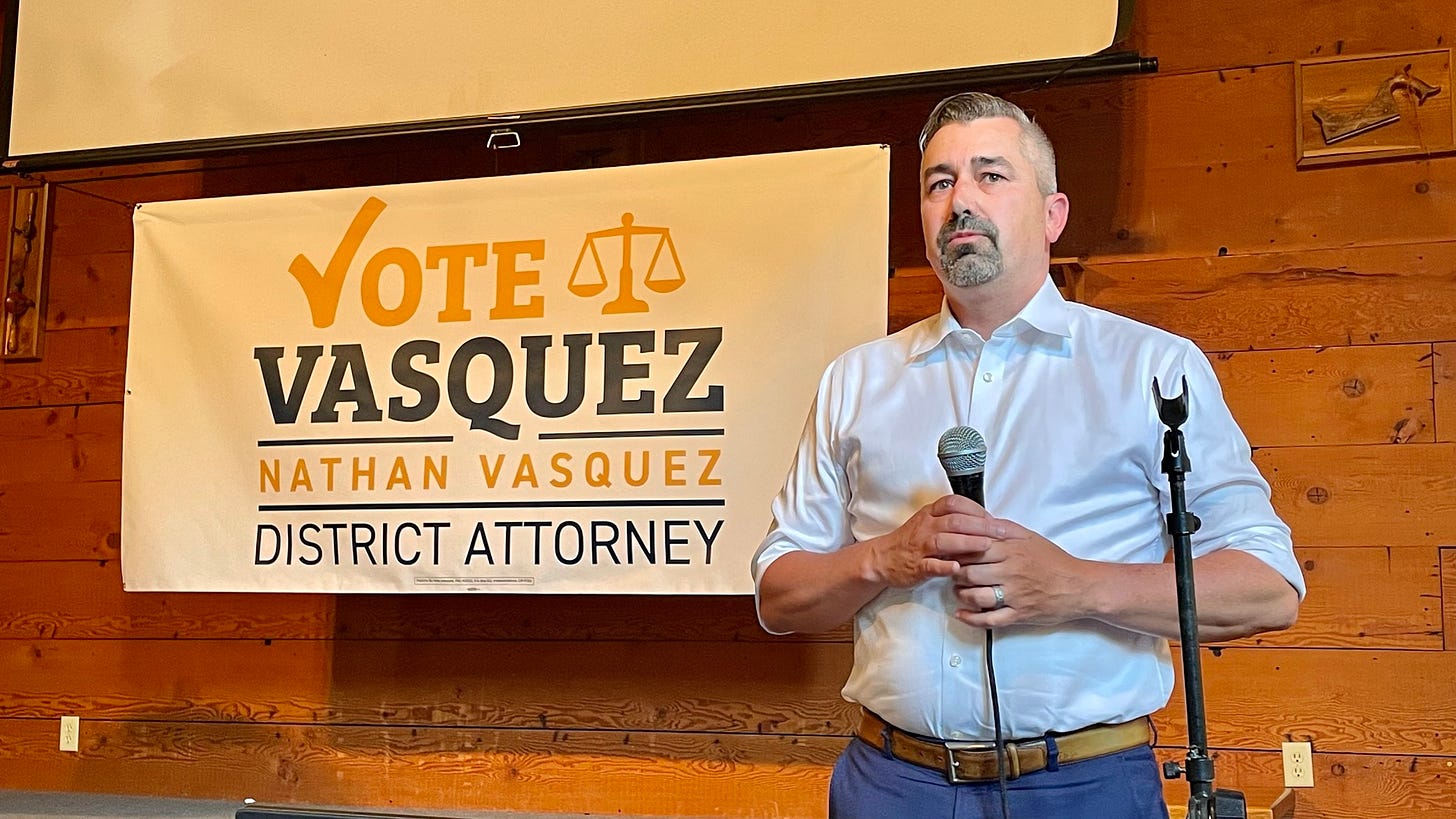 May be an image of 1 person and text that says 'VOTE 山 VASQUEZ NATHAN VASQUEZ DISTRICT ATTORNEY'