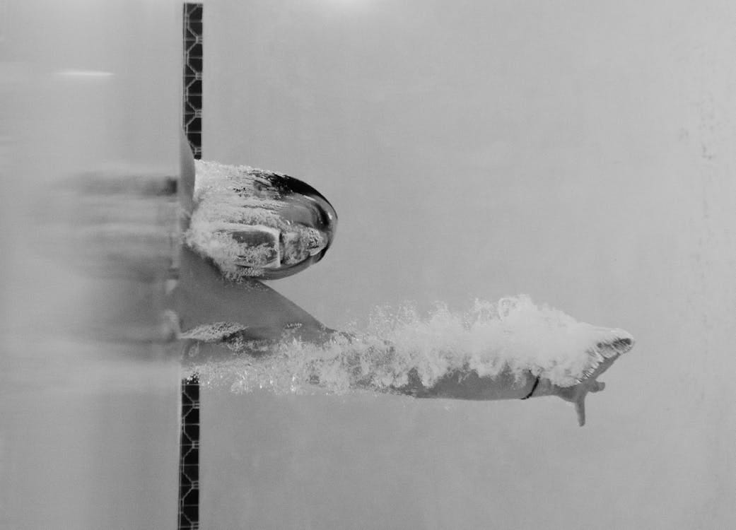 Free Person Swimming at the Pool in Grayscale Photo Stock Photo