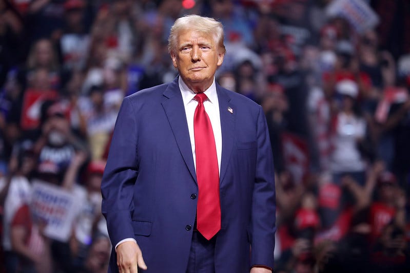 Donald Trump standing in front a rally crowd