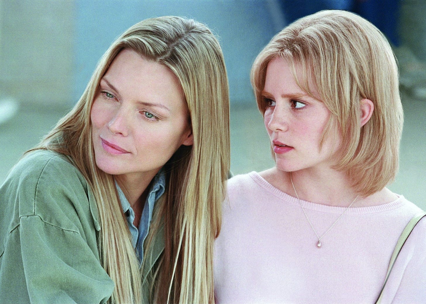 Movie still from White Oleander. A mother sits with her daughter, both blonde