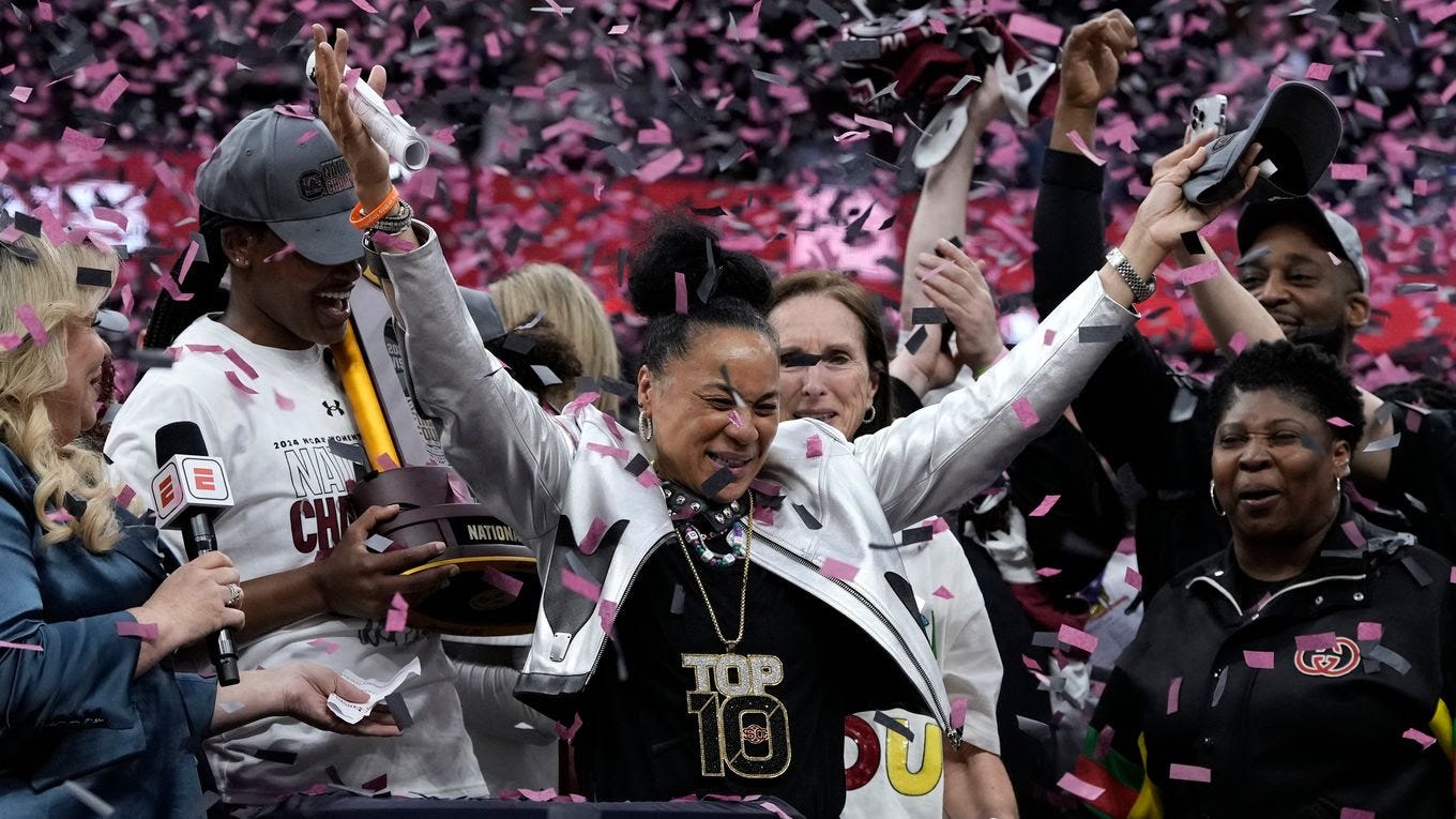 South Carolina coach Dawn Staley celebrates her third women's national championship. She and the Gamecocks also won in 2017 and 2022. (Morry Gash/AP)