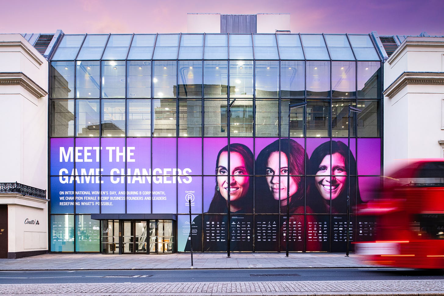 The image is a photo of the window of Coutts bank in central London with a display of female-founded B Corps to celebrate International Women's Day