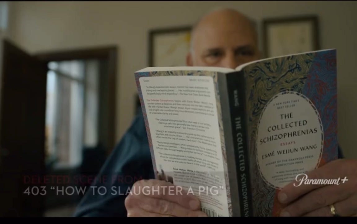 A person holding the book “The Collected Schizophrenias” by Esmé Weijun Wang, with the back cover visible. Text overlay reads: “Deleted Scene from 403 ‘How to Slaughter a Pig’” and “Paramount+.
