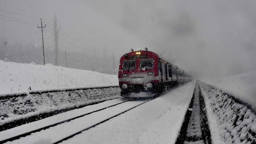 A train moves on a  railway track in Kashmir.