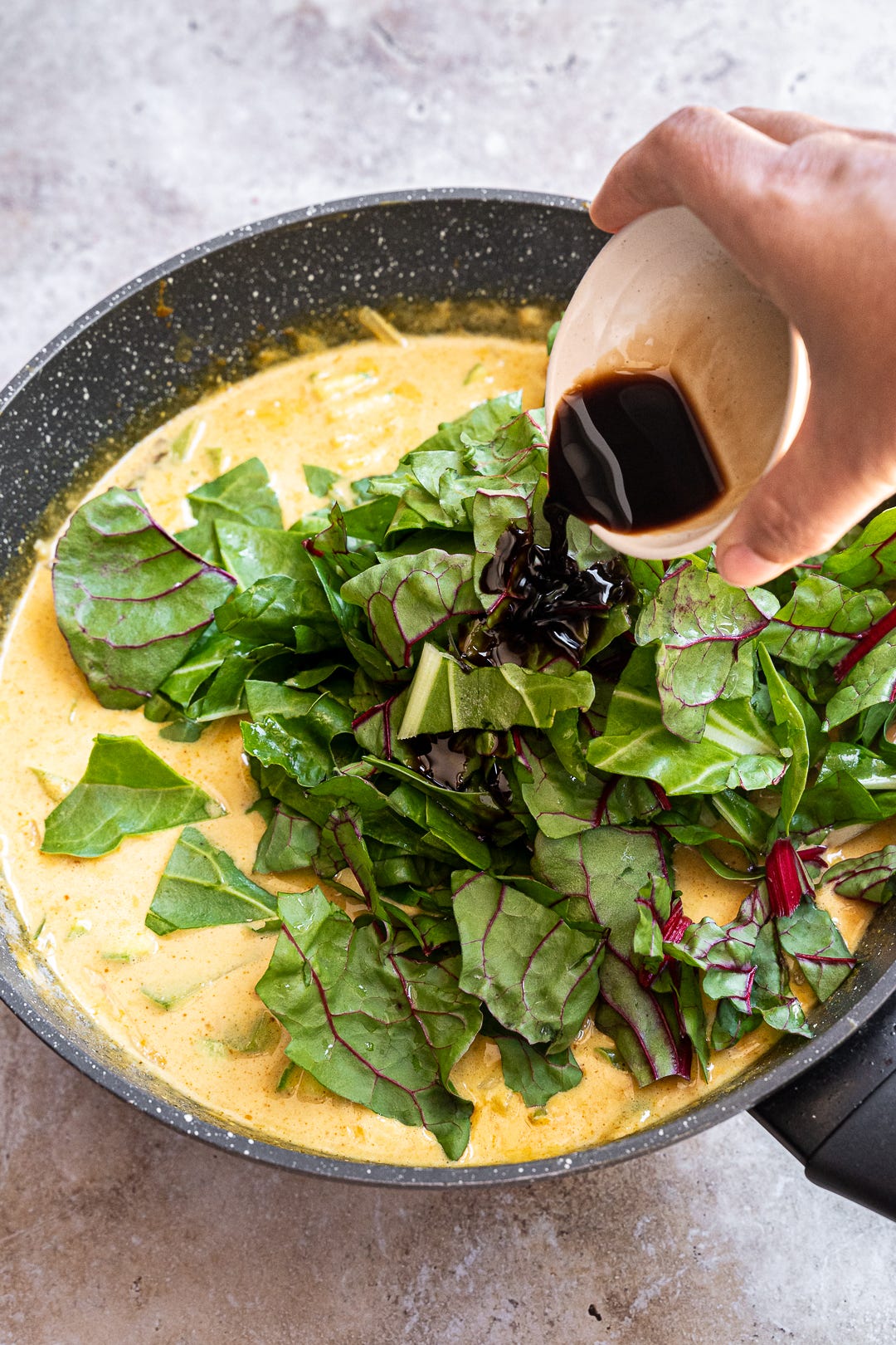 Adding soy sauce to vegetable curry