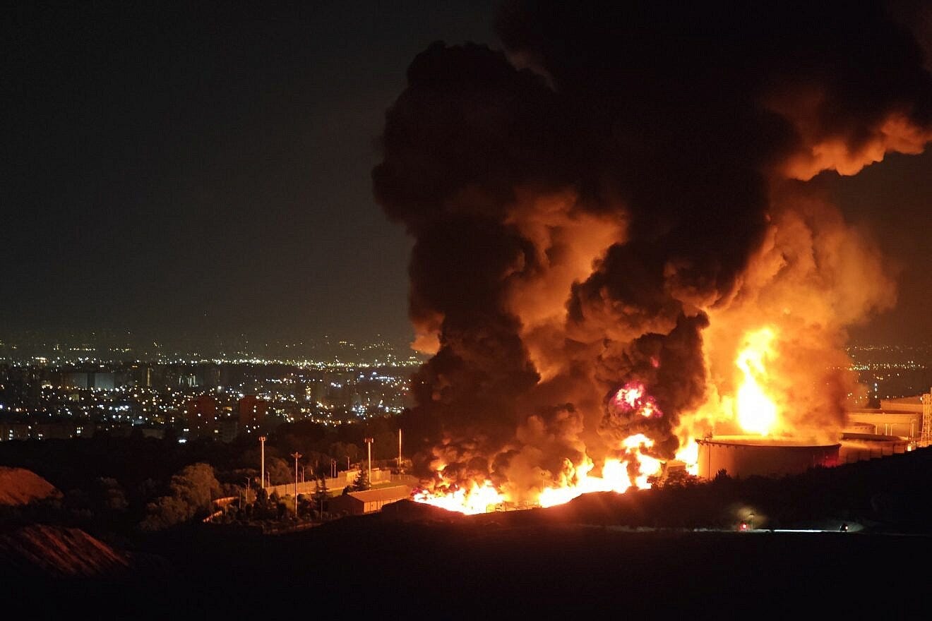 Fire and smoke rise into the sky after an Israeli attack on the Shahran oil depot in Tehran on June 15, 2025. Credit: Stringer/Getty Images.