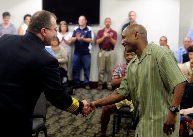 York City Fire Department chief David Michaels, left, shakes hands with retired firefighter Jason Rhoades at the York City Fire Department Awards Ceremony Aug. 28, 2014, at York City Hall. Rhoades had joined the department in 1993. A burn victim thanked a dozen of her emergency responders, a fire captain was promoted and four retiring firefighters and 2013 Firefighter of the Year were recognized during the ceremony.