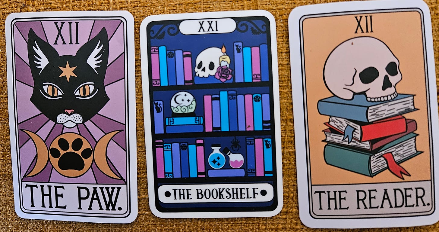 three stickers depicting book-related tarot cards