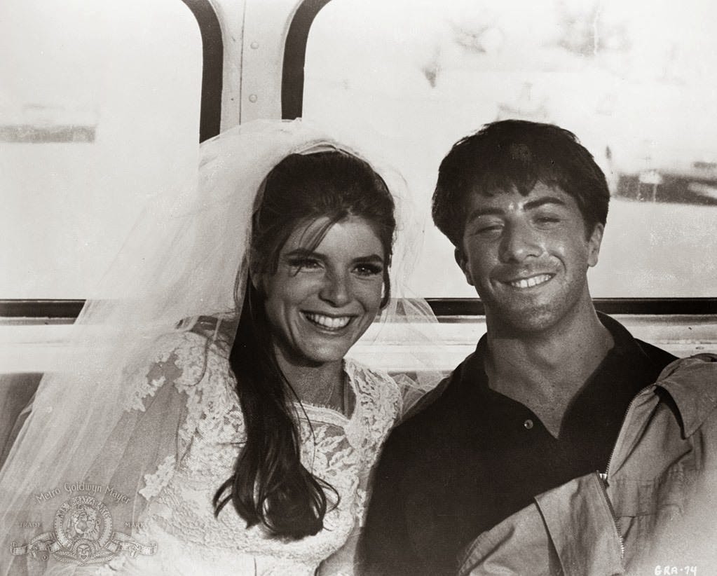 An image from the Graduate of Benjamin and Elaine in the back of a bus, smiling