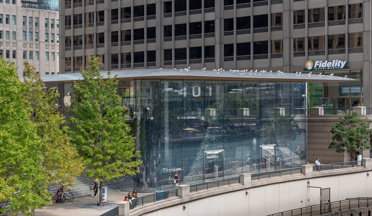 The windows of Apple Michigan Avenue are covered by a curtain display announcing iPhone 15 Pro.
