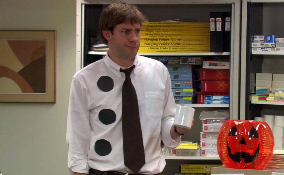 Jim Halpert from the TV show "The Office" dressed as a three-hole punch by taping three black circles to his shirt Jim Halpert from the TV show "The Office" dressed as a three-hole punch by taping three black circles to his shirt