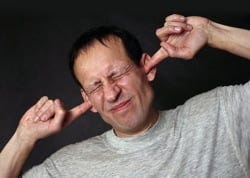 Ears man with fingers in ears