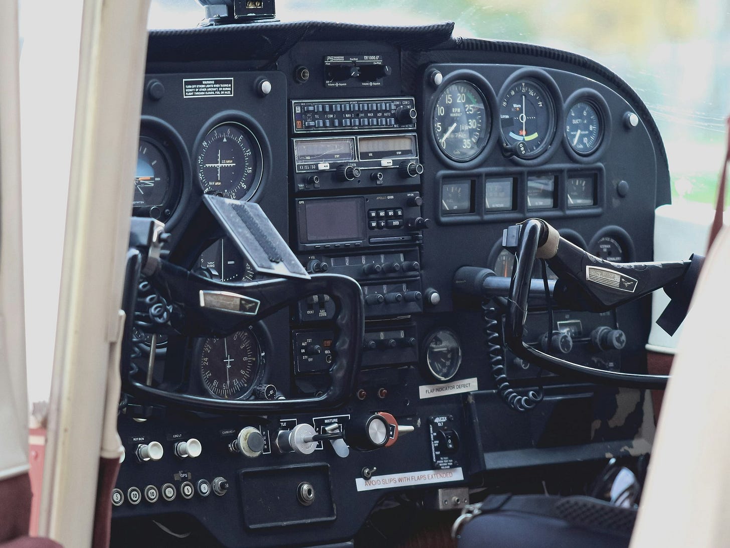 the cockpit of a small airplane with a lot of instruments