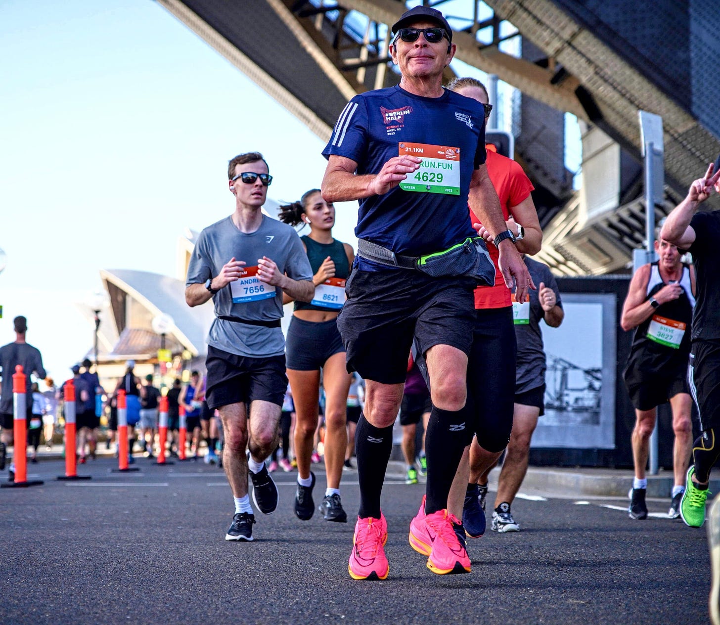 HOKA Runaway Sydney Half Marathon, runners under the Sydney Harbor Bridge near Sydney Opera House