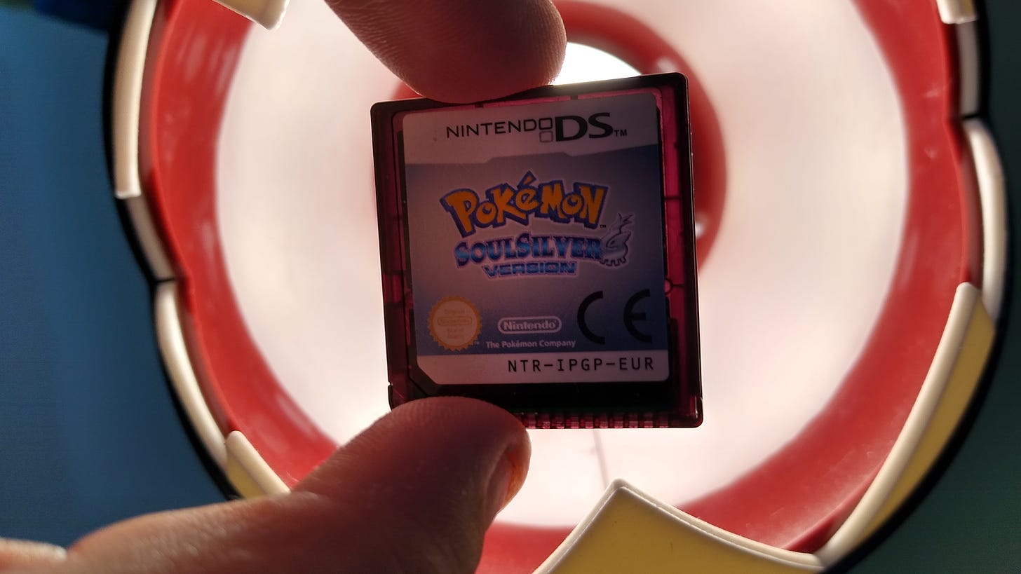 Holding up a copy of HeartGold, SoulSilver, Black, White, Black 2 or White 2, should show that the plastic is a dark red/purple colour so IR light can pass through, and an indicator of its authenticity (Photo credit: Johto Times)